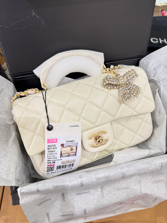 CHANEL Premium Quilted Mini Top Handle Flap Bag with Crystal Bow Charm