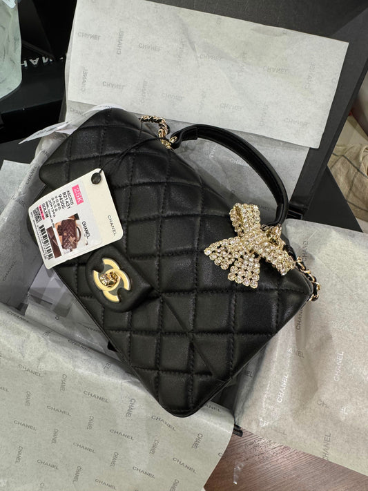 CHANEL Premium Quilted Mini Top Handle Flap Bag with Crystal Bow Charm